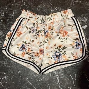 Women running white floral black outlined shorts